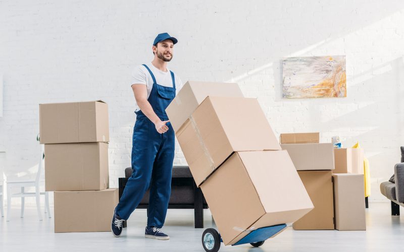 mover-in-uniform-transporting-cardboard-boxes-on-X6KAQDN-rb5ceg9k1vh3br47x0st7wqmkud93e4ja7agbkffd4.jpg